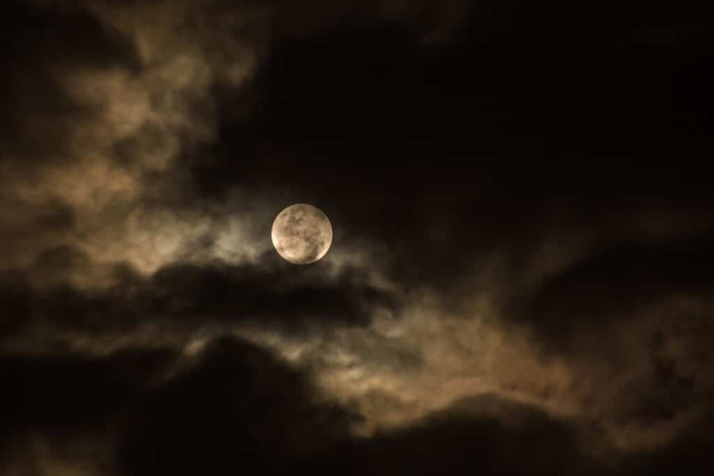 Full moon behind clouds
